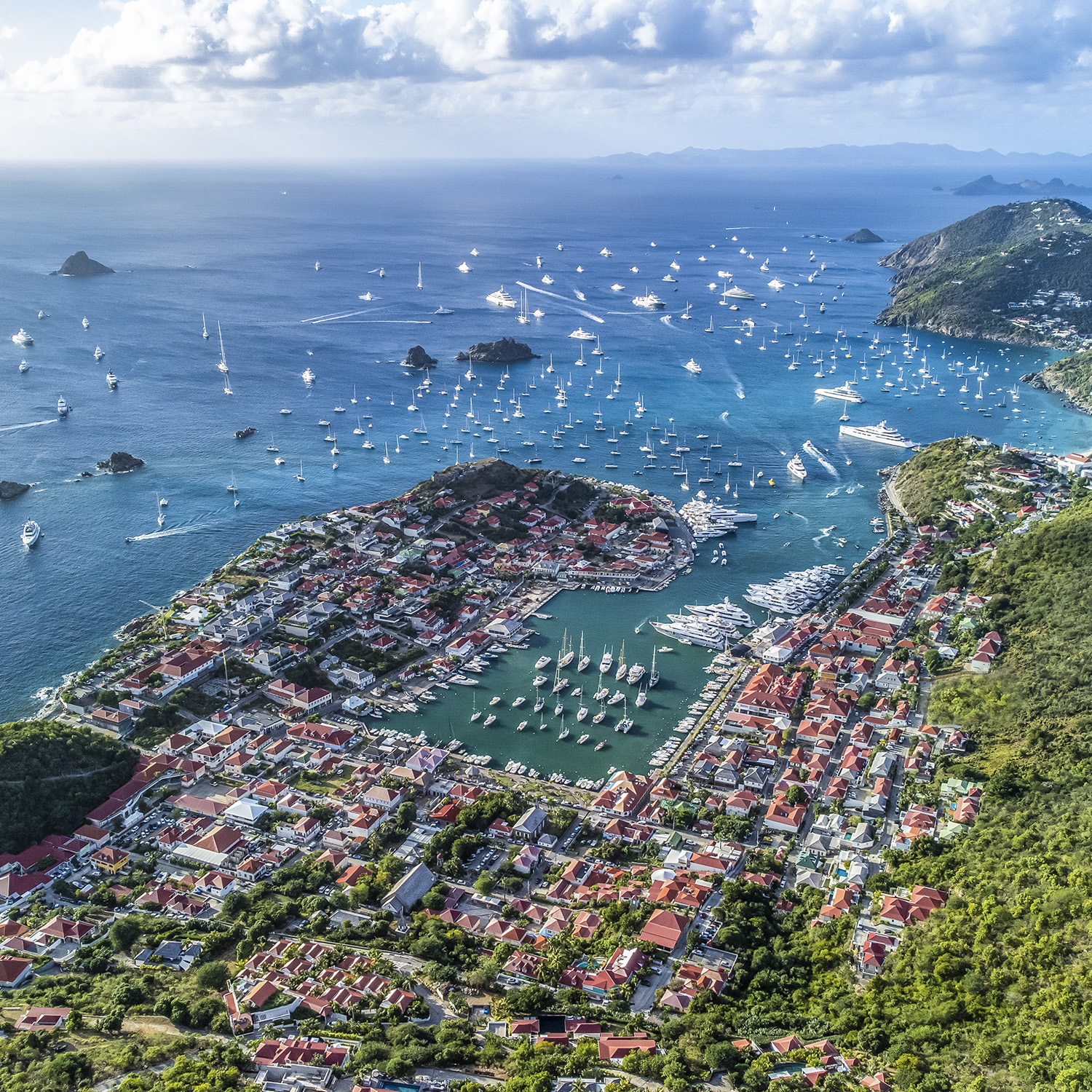 Luxury yachts anchored in Gustavia during holiday season celebrations.
